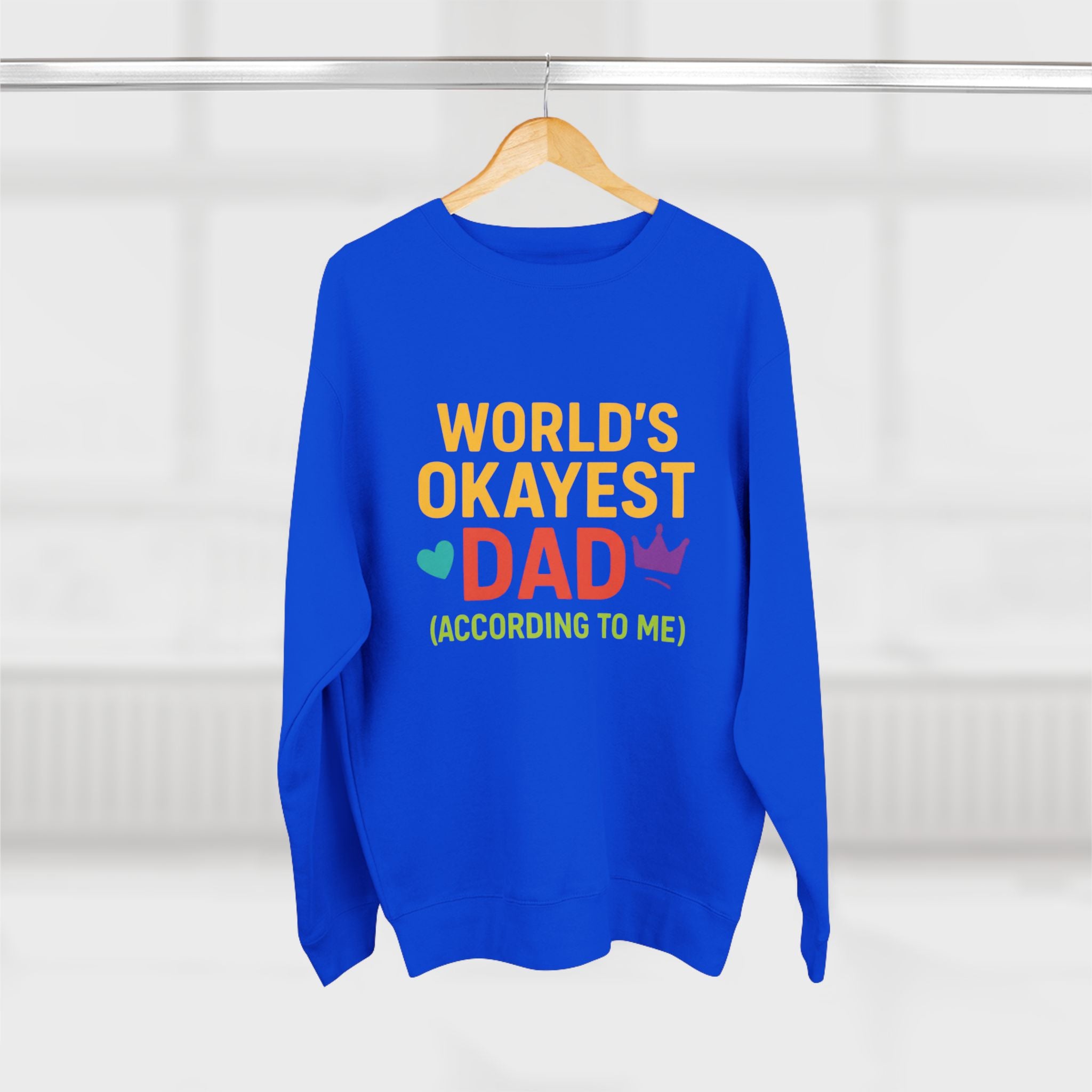 Blue sweatshirt with colorful text on a hanger against a white background