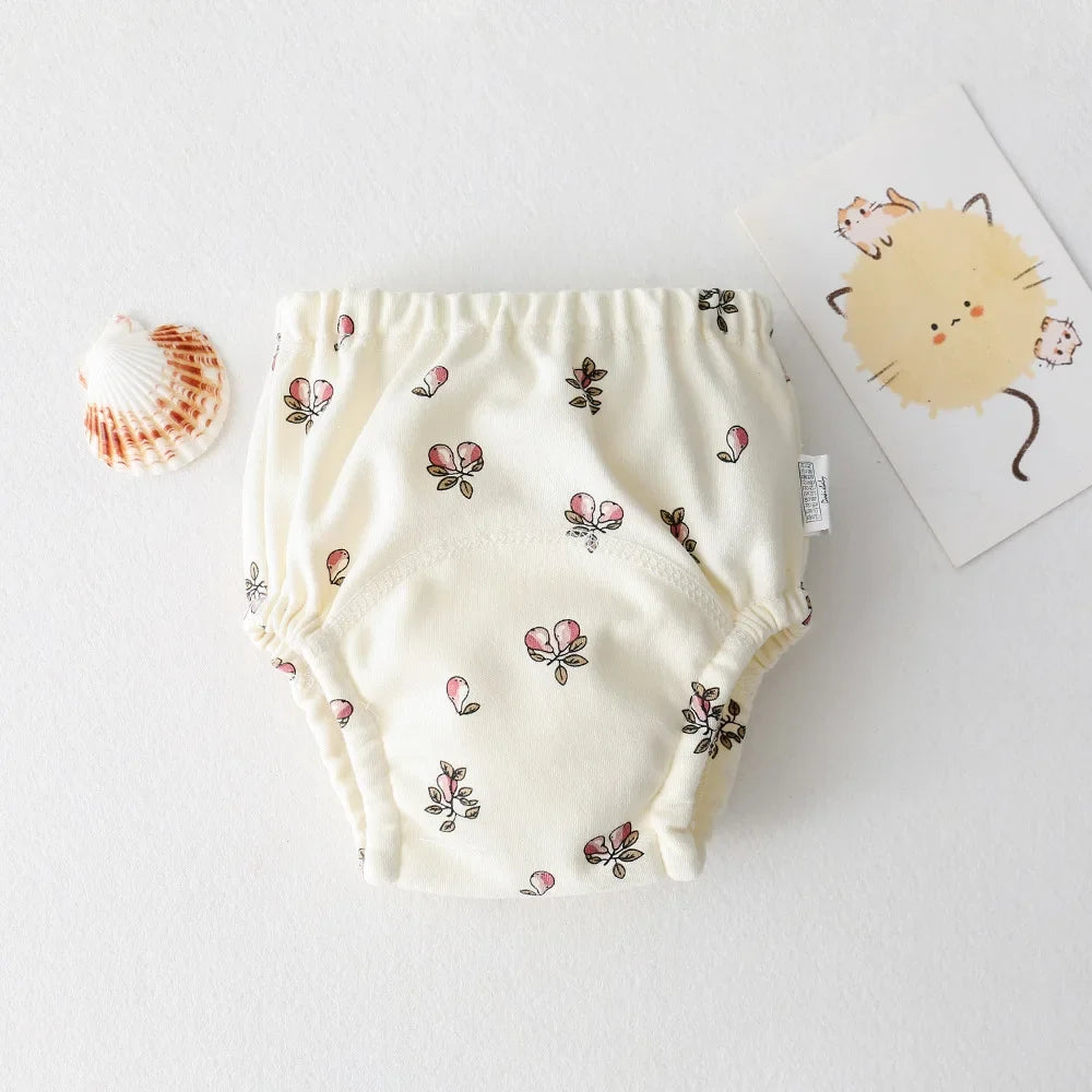 Parwani reusable baby training pants with pink floral print on a cream background