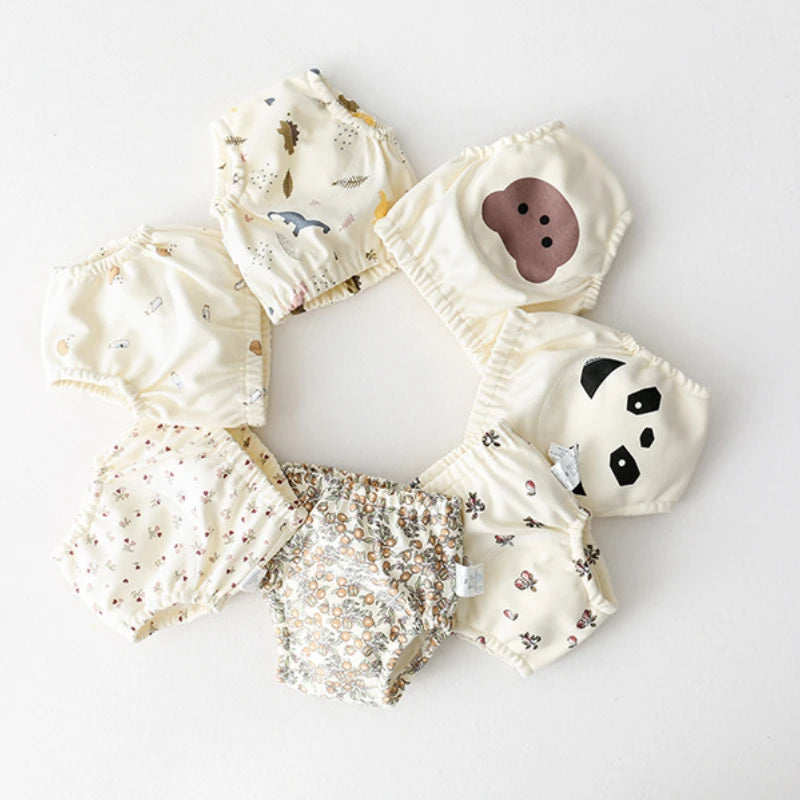 Parwani reusable baby training pants in various cute animal and floral prints arranged in a circle